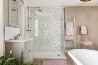 Shower cubicle with patterned tiling in feminine bathroom