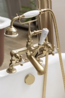 Detail of vintage style mixer taps over bath