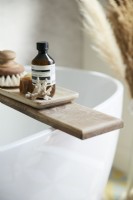 Detail of bath wooden bath rack on oval freestanding bath