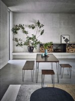 Dining table and stools in industrial concrete room