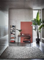 Desk, chair and shelves in an industrial concrete setting