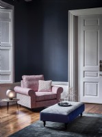 Pink chair in blue room 