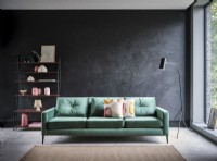 Green sofa against grey mottled wall