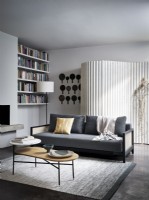 Grey sofa infont of curved feature screen