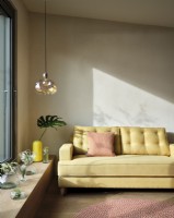 Yellow sofa with glass pendant light