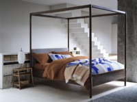 Four poster bed in open plan industrial space