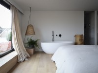Freestanding bath in modern bedroom