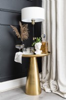 Detail of corner drinks table with lamp in a living room