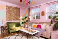 Colourful living room with pink and green velvet sofas