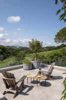 Outdoor living area on raised terrace with countryside views