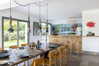 Modern kitchen diner with ceramic pendant lights over dining table