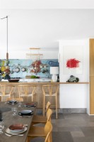 Modern kitchen-diner with colourful splashback feature wall