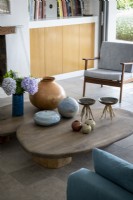Ceramic objects on low wooden coffee table in modern living room
