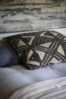 Patterned cushion on bed - detail