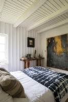 Large artwork on wall of country bedroom
