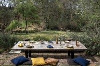 Rustic outdoor dining table laide for lunch overlooking garden