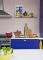 Colourful kitchen detail with cobalt blue cabinets and open shelving.