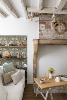 Country living room with wallpaper lined alcove shelving