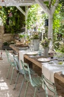 Rustic oudoor dining table laid for lunch