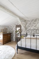 Country bedroom with floral wallpaper