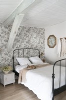 Rabbit on black iron framed bed in country bedroom