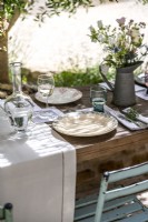 Detail of country garden with dining table laid for lunch