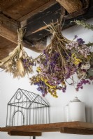 Detail of dried flowers hanging from exposed wooden beams