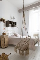 Macrame swing seat in childs country bedroom