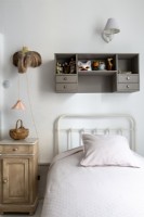 White metal framed single bed in childs bedroom