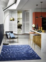 White shutters as partition in kitchen doorway