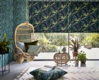 Hanging chair with tropical themed roman blinds and wallpaper