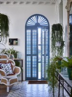 Arched window with blue shutters