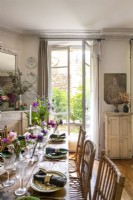 French windows open in retro style dining room