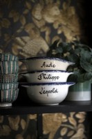 Detail of personalised bowls on kitchen shelf