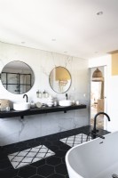 Twin sinks in contemporary monochrome bathroom
