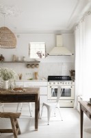 White country style kitchen with large wooden table