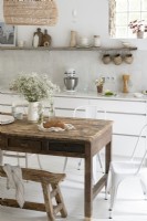 White country kitchen with large wooden table and bench