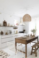 White country kitchen diner with large wooden table and bench