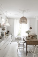 White painted country kitchen-diner with wooden table