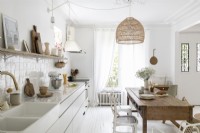 White country kitchen-diner with wooden table