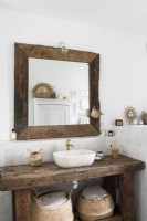 Wooden furniture in white country bathroom