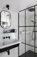 Black and white modern bathroom sink and shower cubicle