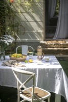 Outdoor dining table with tablecloth in summer 