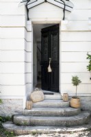 Baskets on stone steps leading up to country house front door