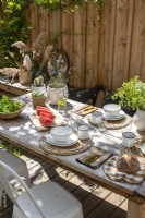 Outdoor dining table laid for lunch in summer