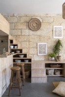 Exposed stone wall in open plan living space 