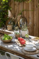 Watermelon and salad on outdoor dining table set for lunch