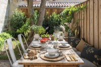 Outdoor dining table in small courtyard garden