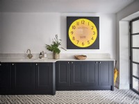 Large modern clock on kitchen wall