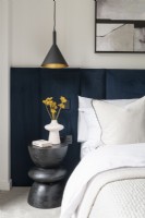 Detail of modern bedside with padded headboard